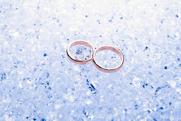 Two golden wedding rings on ice