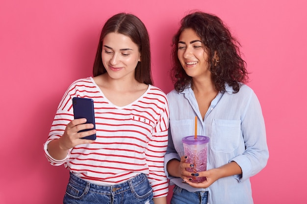 Two good looking young women standing together