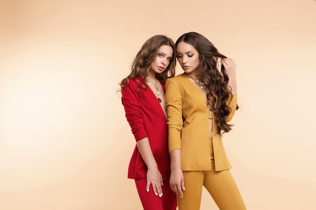 Two gorgeous models in bright suits posing