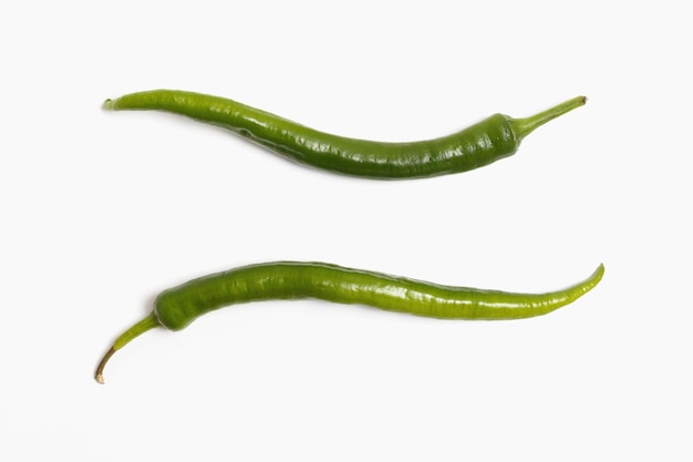 Two green chili peppers isolated on white background top veiw flat lay