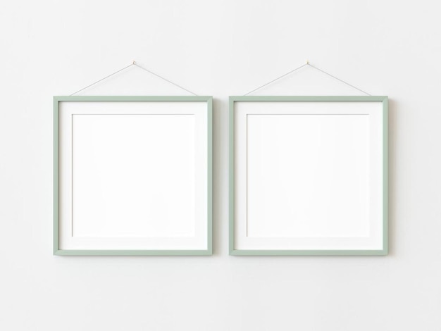Photo two green wooden squared frames hanging on a white textured wall