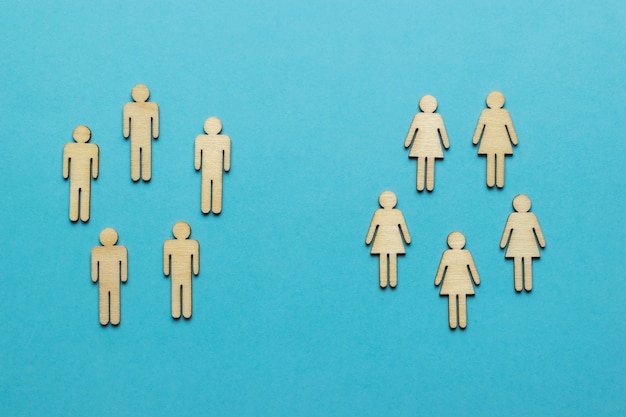 Photo two groups of male and female figures on a blue background.