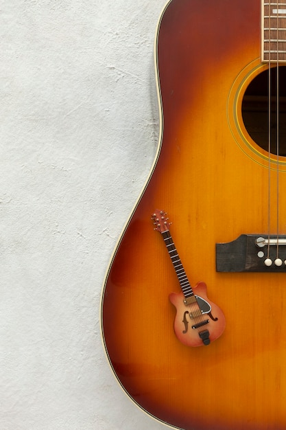 Two guitars big and small on a white background