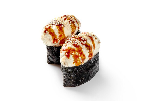 Two gunkan maki with eel topping dressed with unagi sauce and sesame