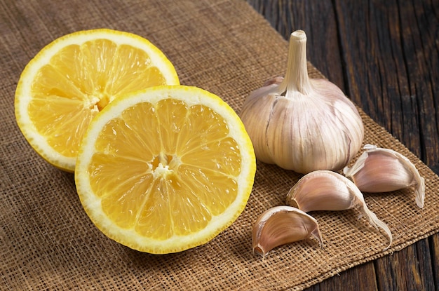 Two halves of lemon and garlic on an old table Healthy eating