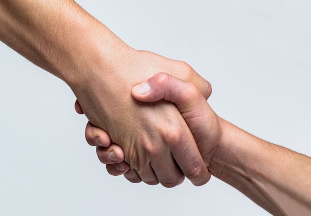 Two hands, helping arm of a friend, teamwork. rescue, helping
gesture or hands. close up help hand. helping hand concept,
support. helping hand outstretched, isolated arm, salvation.