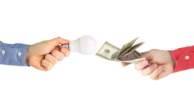 Two hands with dollar bills and led lamp on a white