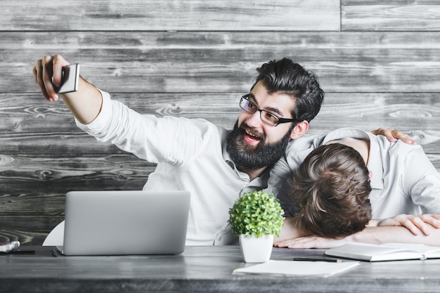 Two handsome businessmen using phone