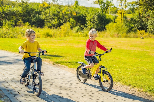 Two happy boys cycling in the park