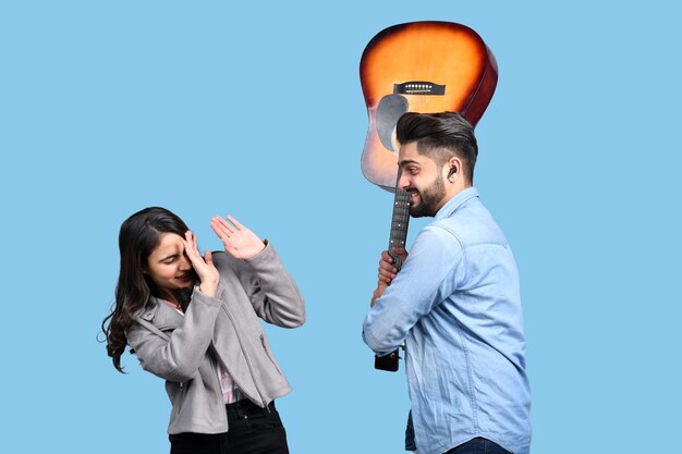 Two happy casual students with guitar indian pakistani model