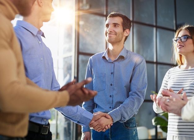 Two happy diverse professional business men executive leaders shaking hands at office meeting