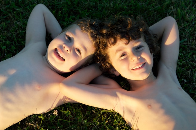 Two happy friends in the green grass