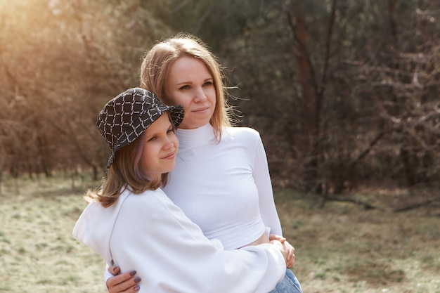 Two happy girls smiling portrait of women hugging the concept of relationships in the family friends...