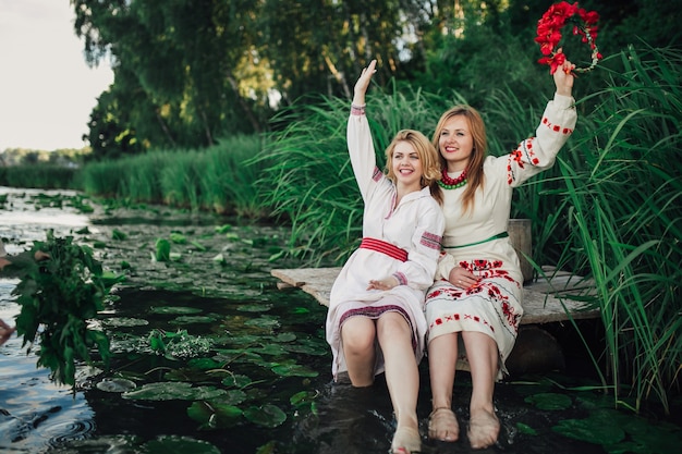 two happy girls with feet in water