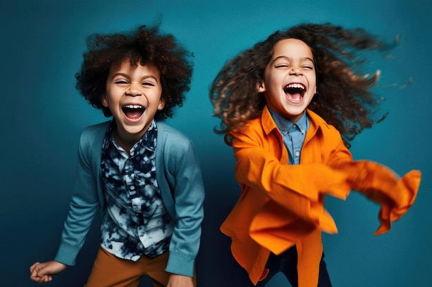 Two happy kids are smiling and laughing on blue background