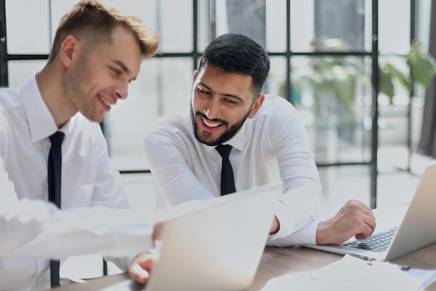 Two happy men working together on a new business project