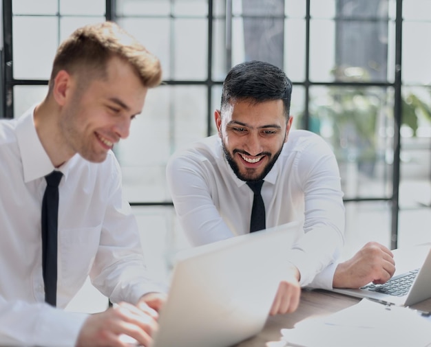 Two happy men working together on a new business project