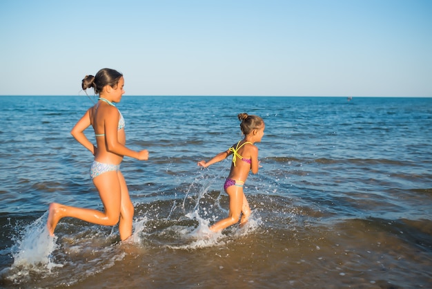 Two happy and positive girls sisters run