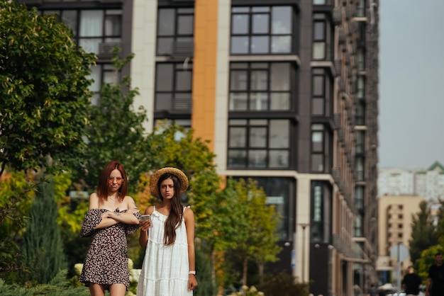 Two happy tourists with a phone on a city street