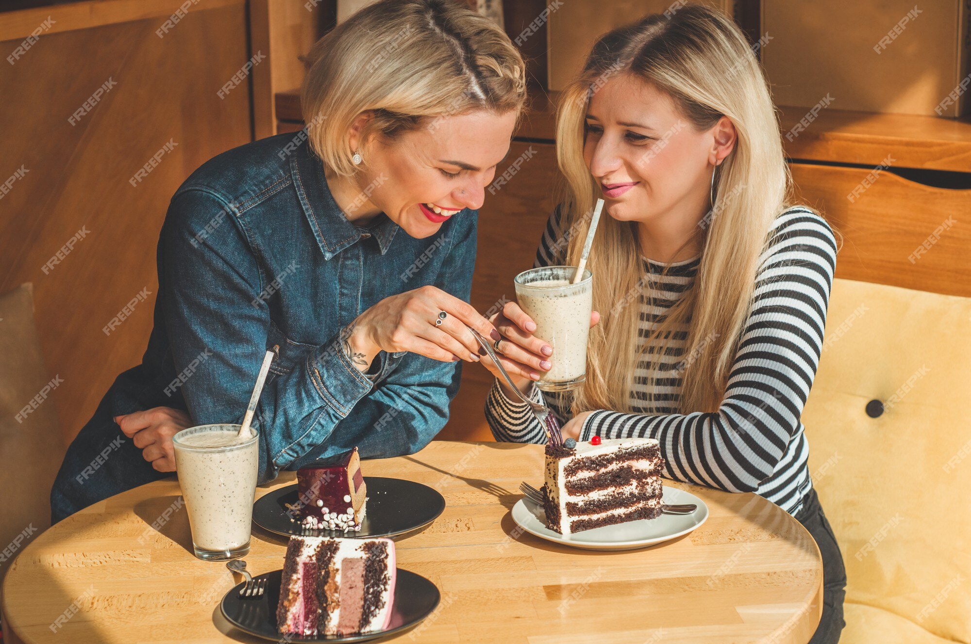 Premium Photo | Two happy women sitting in a cafe, drink a cocktail, tell each other funny stories, being in a good mood, laughing happily. best friends Premium Photo | Two happy women sitting in a cafe, drink a cocktail, tell each other funny stories, being in a good mood, laughing happily. best friends