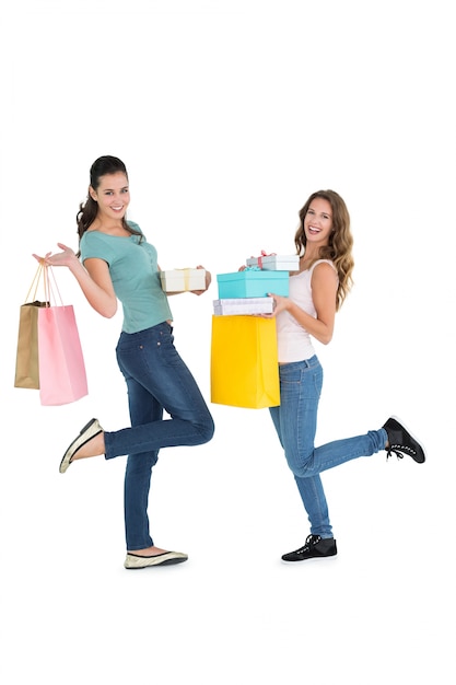 Two happy young female friends with shopping bags