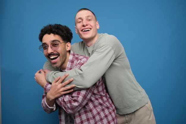 Two happy young men hugging