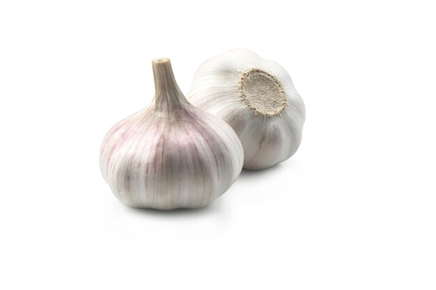 Two heads of garlic laying on white background