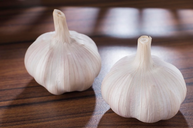 Two heads of garlic on the table approach