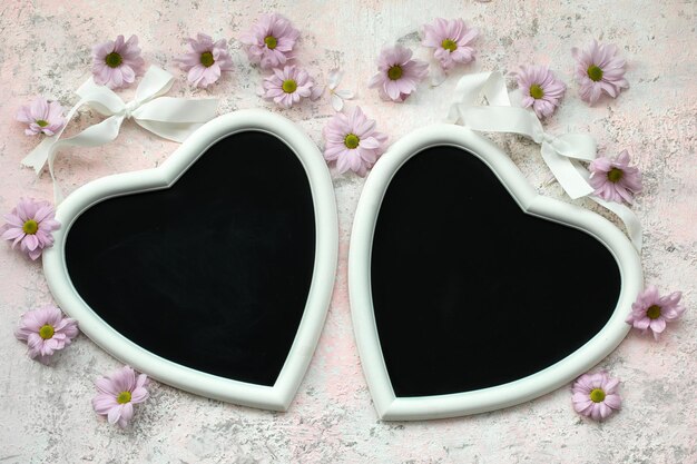 Two hearts on a pink background and chrysanthemums