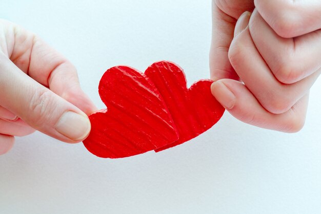 Two hearts in their hands.