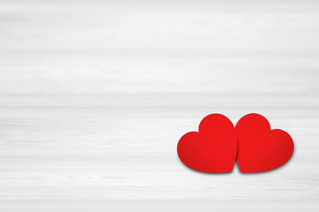 Two hearts on white wood background. Valentines Day concept.