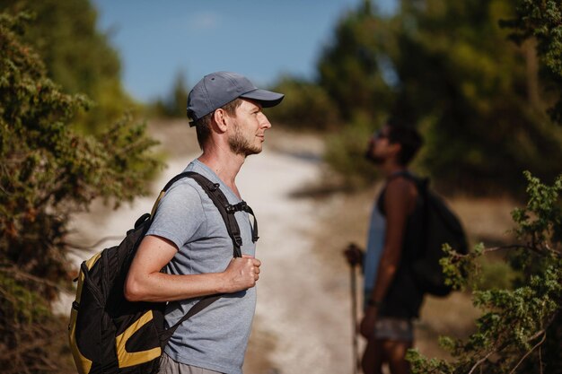 Two hikers men walk on trek in mountain trekking in mountains\
hills and mounts in sport tourism