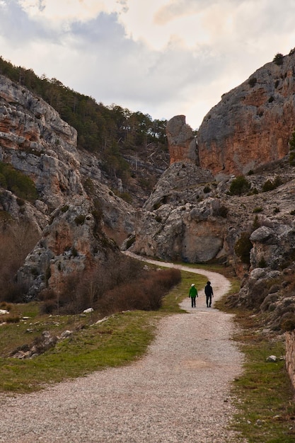 Two hikers walking in a canyon