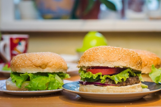 Two Homemade burger with tomato and beef patty fresh toppings on whole grain