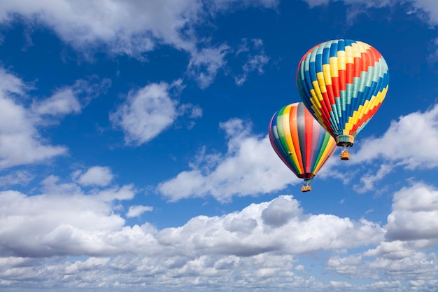 Two Hot Air Balloons Up In The Beautiful Blue Sky