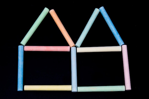 Two houses with keys from a chalk on a black board