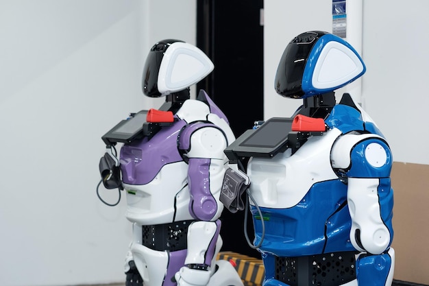 two humanoid robots guides with medical functions in the workshop where they were assembled