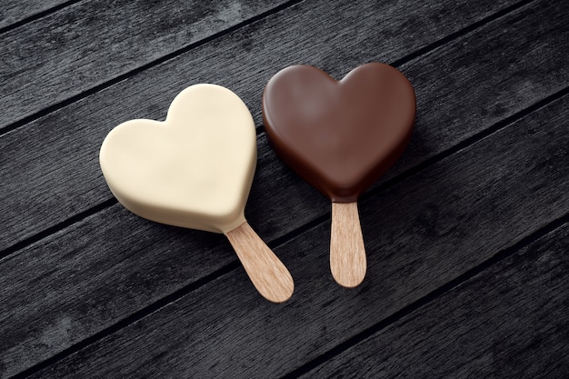 Photo two ice creams with heart shape on wood