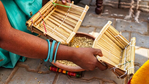 Two indian women in wedding ceremony women celebrate wedding rituals with holy things like sorghum seed and turmeric