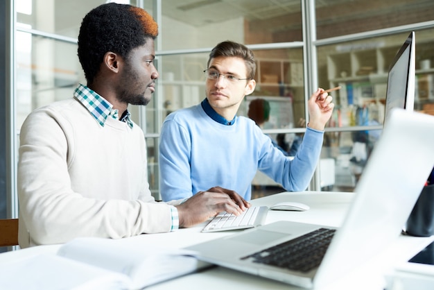 Two IT Programmers Working in Office