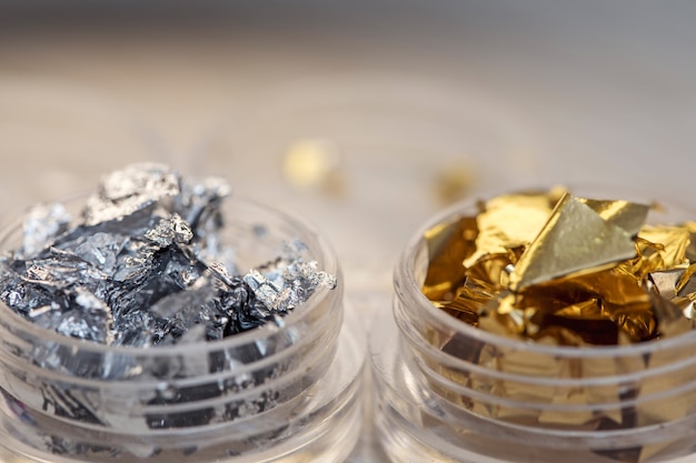 Two jars with foil for nail design close up