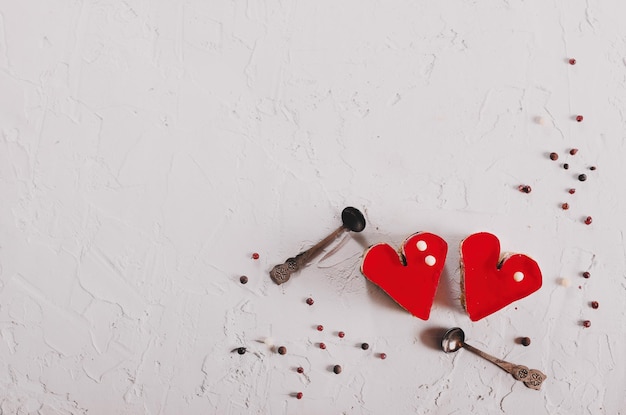 Two jelly heartshaped cakes on white concrete background Free space for your text Toned effect