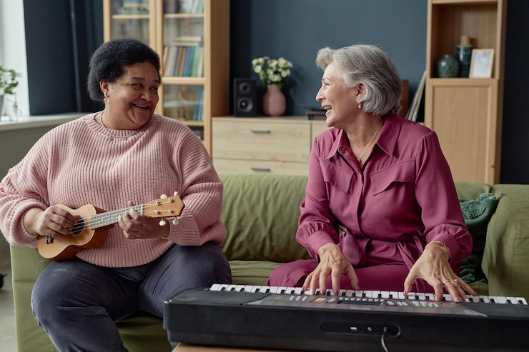 Photo two joyful mature women playing music
