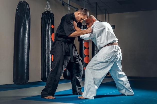 Two judo wrestlers showing their technical skills at fight club.