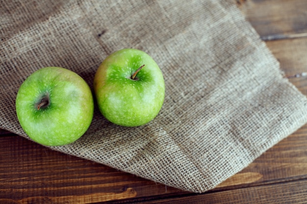 Two juicy green apples on the table. The concept of diet