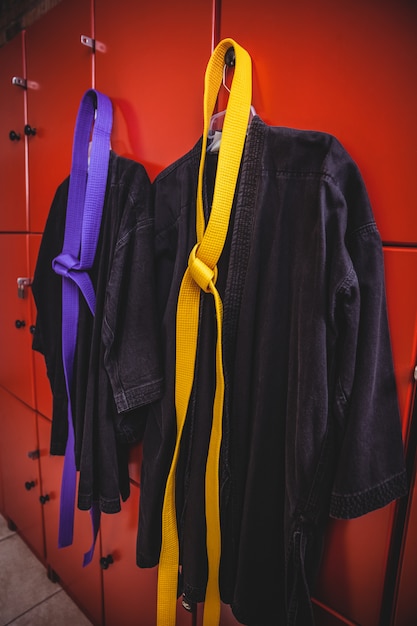 Two karate uniforms hanging on locker