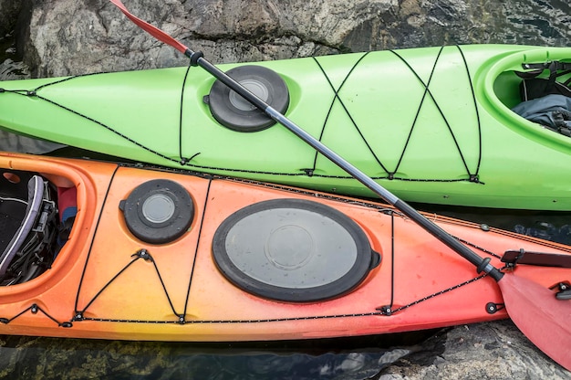 Two kayaks are moored on the rocky shore of the sea Top view