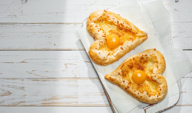 Two khachapuri in the shape of a heart dinner in a Georgian restaurant for two on Valentine's Day