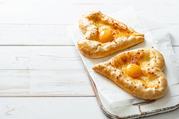 Two khachapuri in the shape of a heart dinner in a Georgian restaurant for two on Valentine's Day