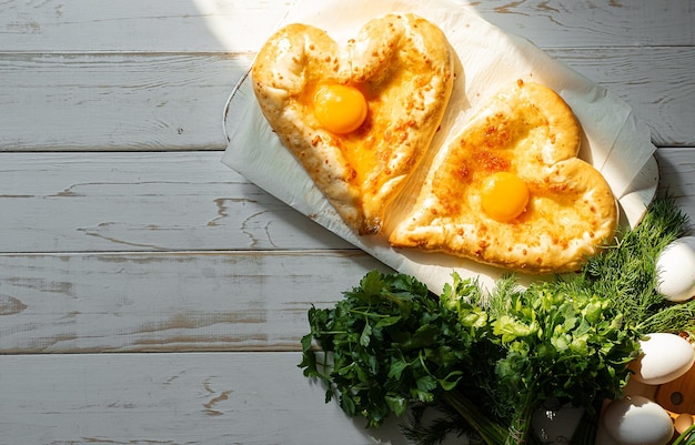 Two khachapuri in the shape of a heart dinner in a Georgian restaurant for two on Valentine's Day